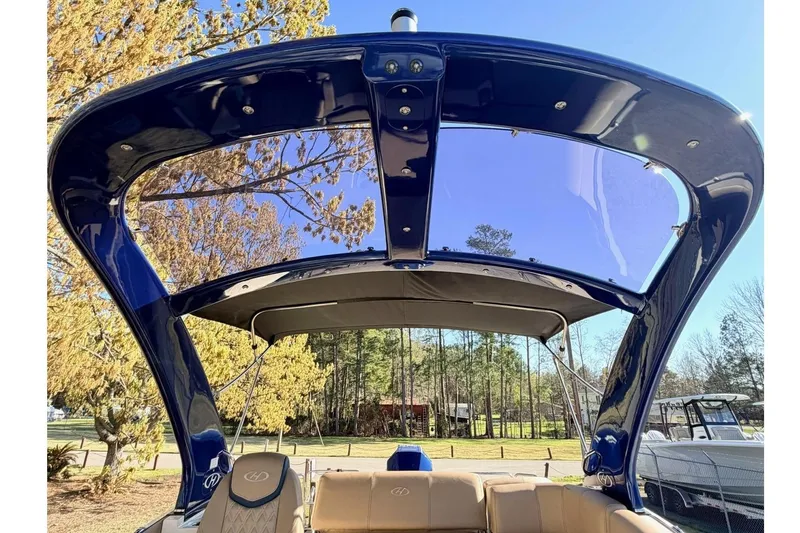 Slide: The Image of 2021 Harris Crowne SL 250 boat with sleek design and spacious seating under a clear blue sky. - 9