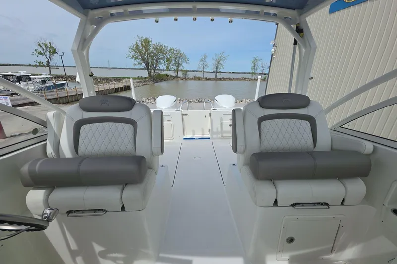 Slide: The Image of 2021 World Cat 296 DC boat interior with plush seating and waterfront view. - 11
