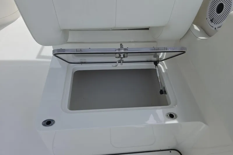 Slide: The Image of Open storage compartment on a 2021 World Cat 296 DC boat, featuring a clear lid. - 15
