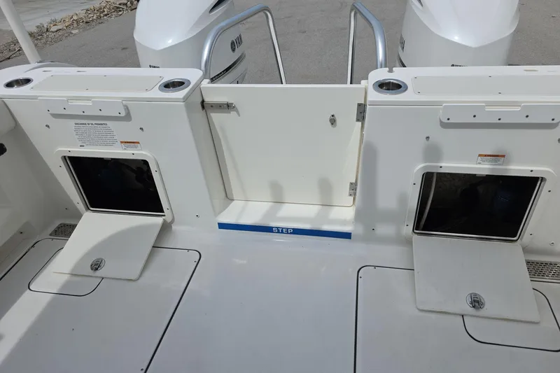 Slide: The Image of 2021 World Cat 296 DC boat deck with storage compartments and step. - 16