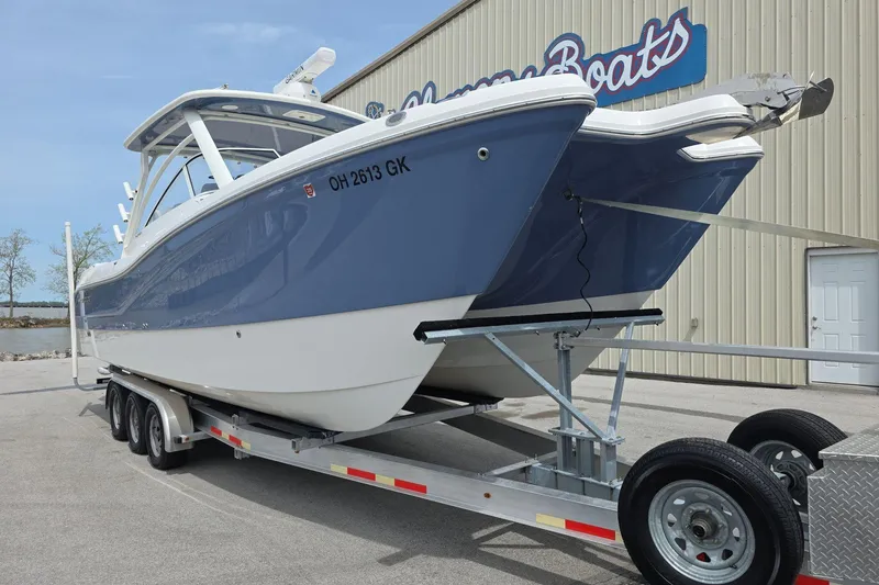 Slide: The Image of 2021 World Cat 296 DC boat on trailer, parked outside showroom. - 2