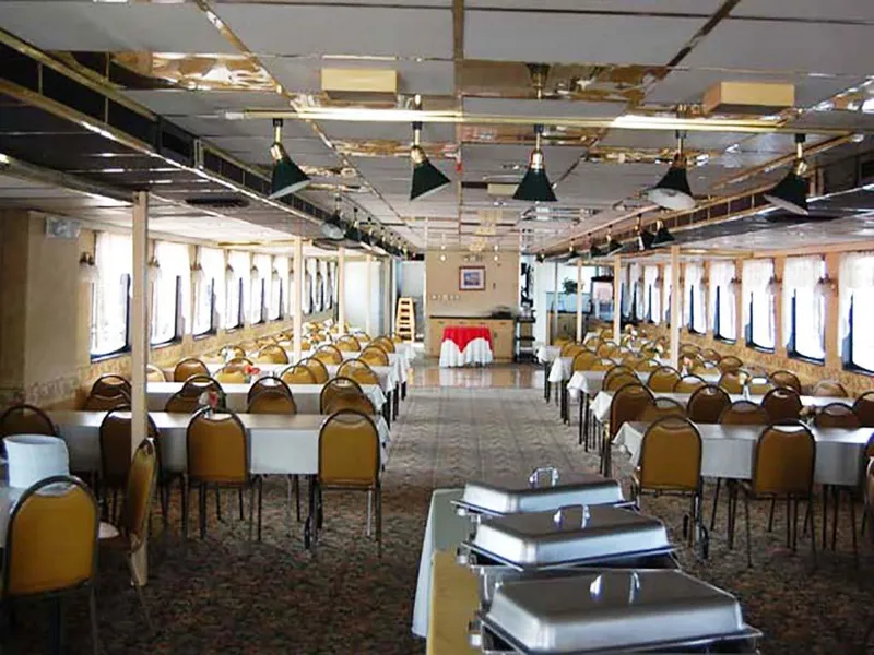 Slide: The Image of Interior of 1985 Custom Serodino Dinner Boat with elegant dining setup and buffet tables. - 16