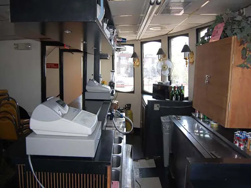 Slide: The Image of Interior of 1985 Custom Serodino Dinner Boat with bar area and cash registers. - 29