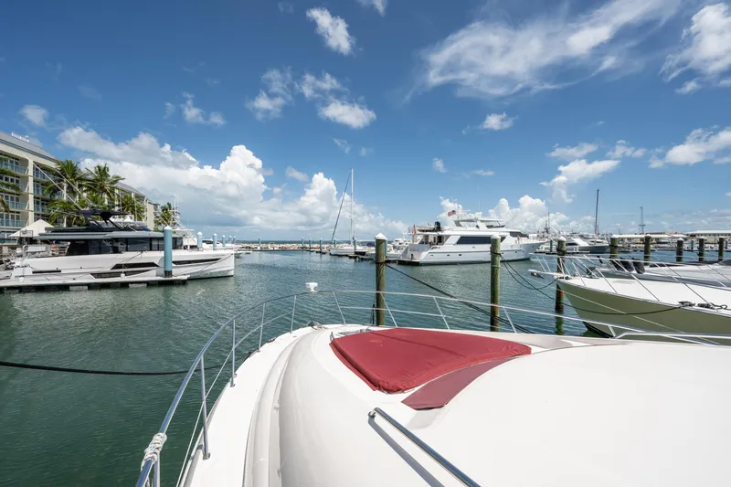 Slide: The Image of Marina view with 2003 Sea Ray 480 Motor Yacht under clear blue sky. - 11