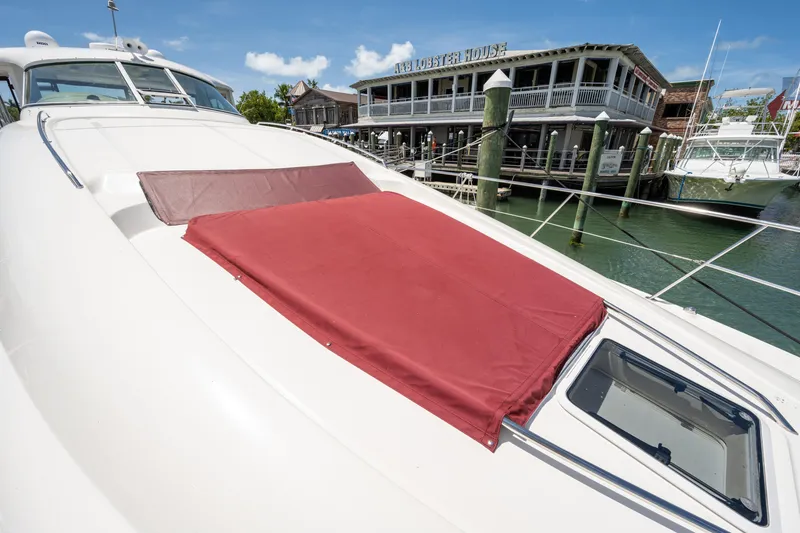Slide: The Image of 2003 Sea Ray 480 Motor Yacht docked near waterfront restaurant, sunny day. - 14