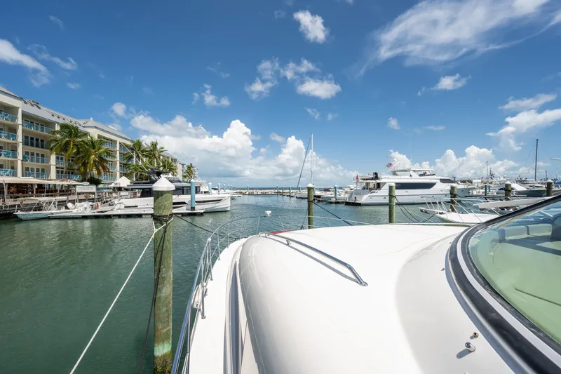 Slide: The Image of 2003 Sea Ray 480 Motor Yacht docked in a sunny marina with clear skies. - 17