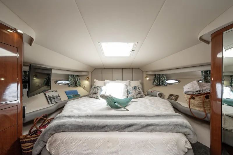 Slide: The Image of Luxurious 2003 Sea Ray 480 Motor Yacht bedroom with elegant decor and natural light. - 20
