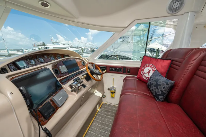 Slide: The Image of Interior of 2003 Sea Ray 480 Motor Yacht with red seating and navigation controls. - 27