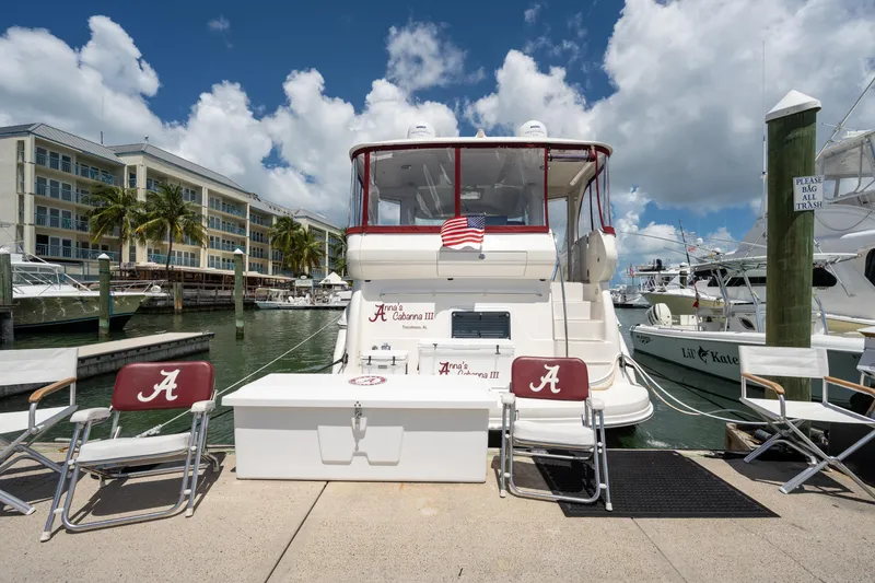 Slide: The Image of 2003 Sea Ray 480 Motor Yacht docked at marina with chairs and American flag. - 3