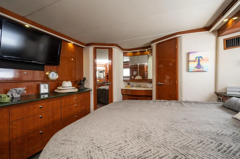 Slide: The Image of Luxurious 2003 Sea Ray 480 Motor Yacht bedroom with elegant wood cabinetry and modern decor. - 40