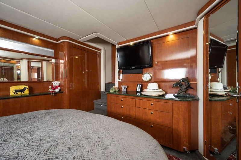 Slide: The Image of Luxurious 2003 Sea Ray 480 Motor Yacht bedroom with elegant wood cabinetry and modern amenities. - 41