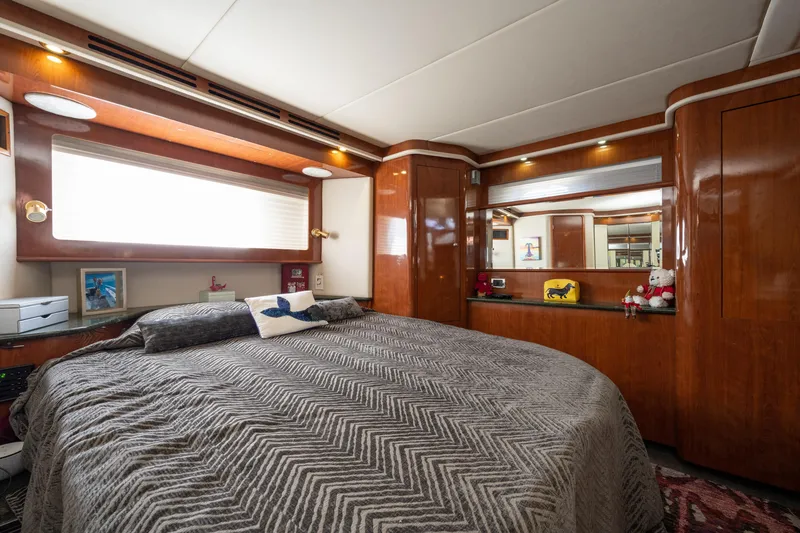 Slide: The Image of Luxurious bedroom interior of 2003 Sea Ray 480 Motor Yacht with wood paneling and cozy bedding. - 43