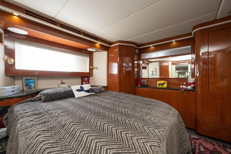 Slide: The Image of Luxurious bedroom interior of 2003 Sea Ray 480 Motor Yacht with wood paneling and cozy bedding. - 44