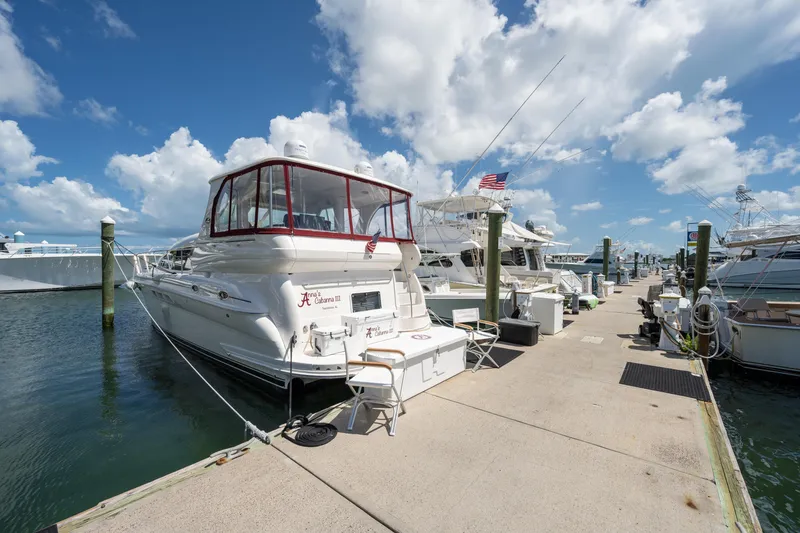 Slide: The Image of 2003 Sea Ray 480 Motor Yacht docked at marina under blue sky. - 5