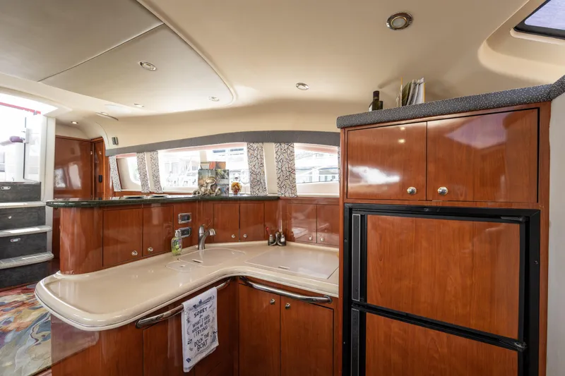 Slide: The Image of Luxurious 2003 Sea Ray 480 Motor Yacht interior with elegant wood cabinetry and modern kitchen amenities. - 50