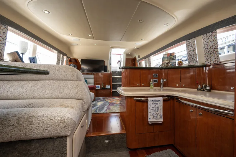 Slide: The Image of Luxurious interior of a 2003 Sea Ray 480 Motor Yacht with elegant wood finishes. - 52