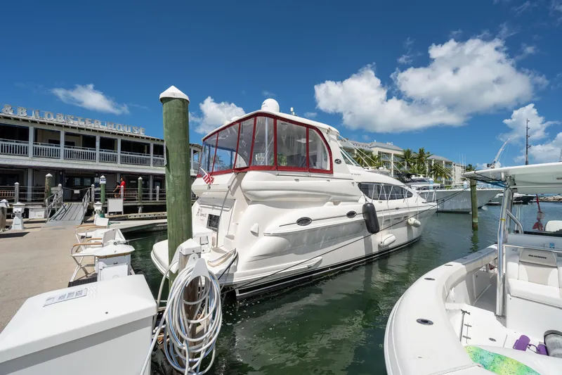 Slide: The Image of 2003 Sea Ray 480 Motor Yacht docked at marina under clear blue sky. - 6