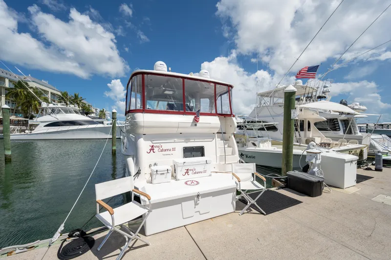 Slide: The Image of 2003 Sea Ray 480 Motor Yacht docked at marina under blue sky. - 7