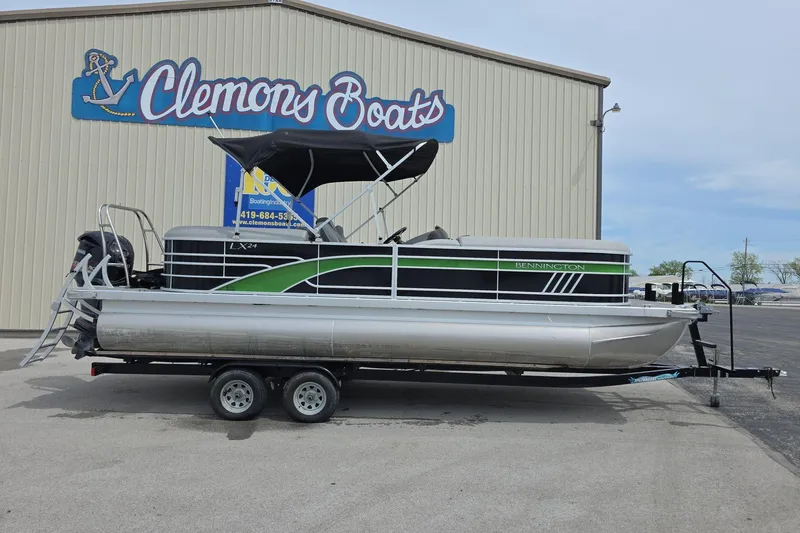 The Image of 2021 Bennington LX 24 Quad Bench pontoon boat on trailer at Clemons Boats dealership. - 0