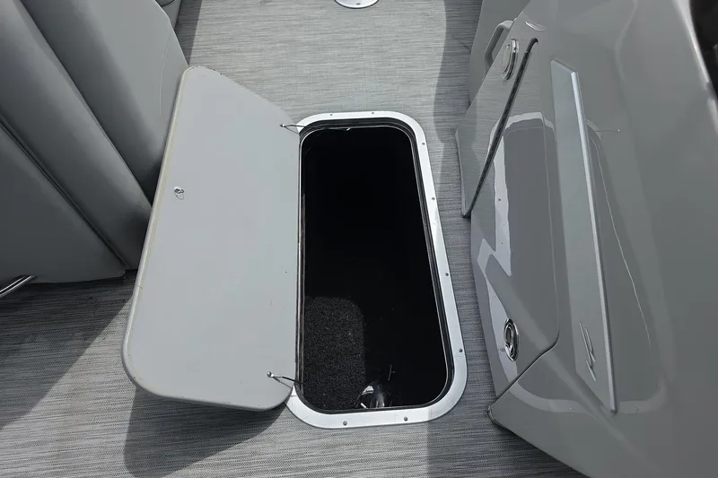 Slide: The Image of Open storage compartment on 2021 Bennington LX 24 Quad Bench boat. - 17