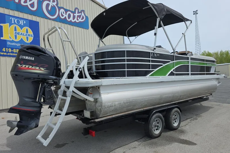 Slide: The Image of 2021 Bennington LX 24 Quad Bench pontoon boat with Yamaha VMAX engine on trailer. - 3