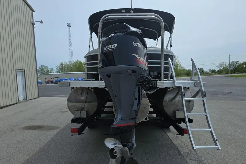 Slide: The Image of 2021 Bennington LX 24 Quad Bench pontoon boat with Yamaha 250 engine, rear view. - 5