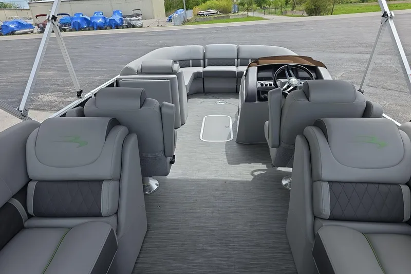 Slide: The Image of 2021 Bennington LX 24 Quad Bench pontoon boat interior with luxurious gray seating and helm. - 6