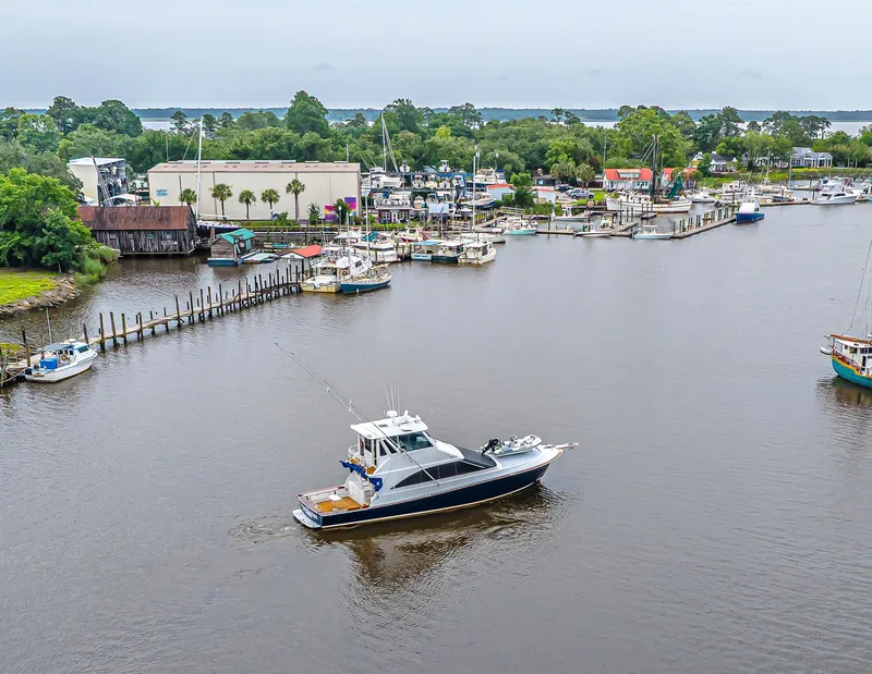 Slide: The Image of Aerial view of 1997 Ocean Yachts 60 Super Sport EB cruising near a marina. - 24