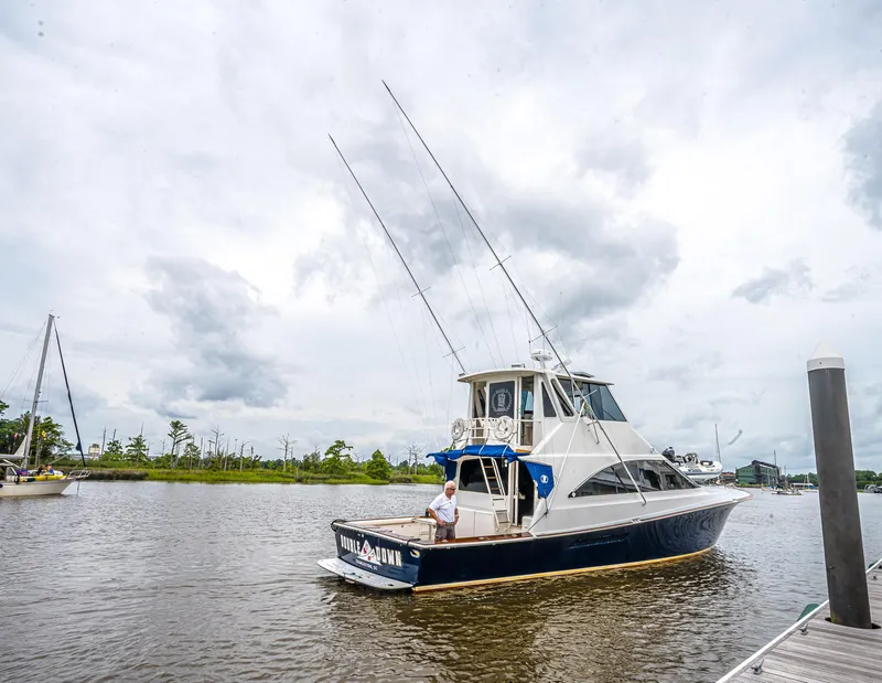 Slide: The Image of 1997 Ocean Yachts 60 Super Sport EB docked on a cloudy day. - 40