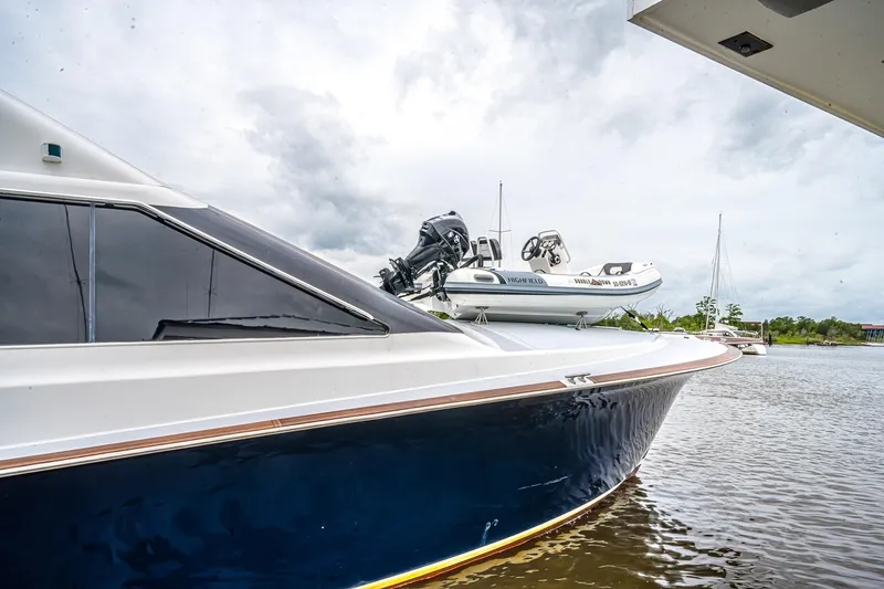 Slide: The Image of 1997 Ocean Yachts 60 Super Sport EB docked with inflatable boat on deck. - 42