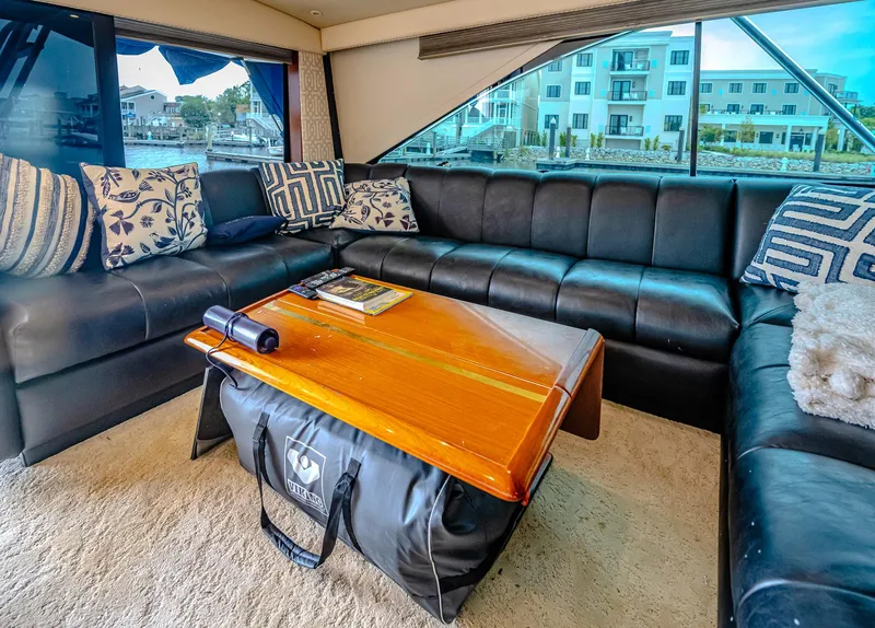 Slide: The Image of Luxurious interior of 1997 Ocean Yachts 60 Super Sport EB with leather seating and wooden table. - 9