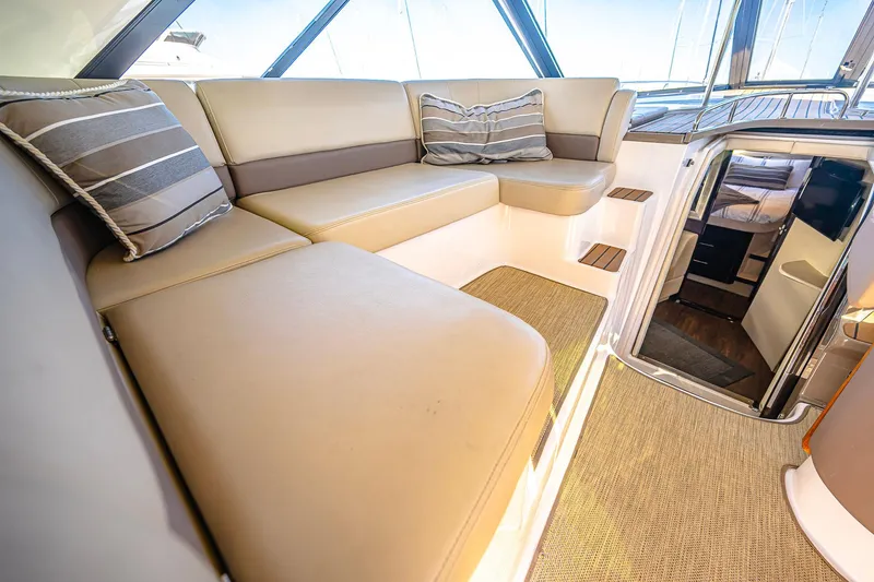 Slide: The Image of Luxurious interior of 2016 Regal 46 Sport Coupe with beige seating and striped cushions. - 15