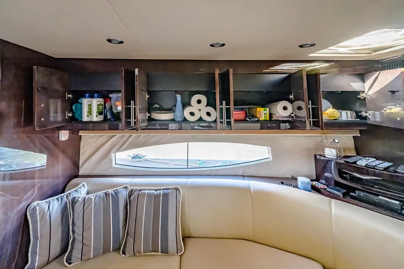Slide: The Image of Interior of 2016 Regal 46 Sport Coupe with open cabinets and striped cushions. - 72