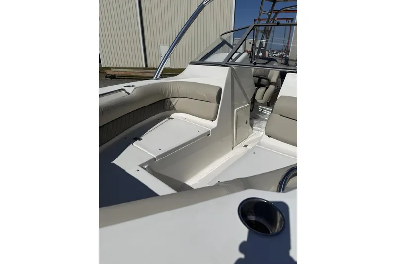 Slide: The Image of 2026 Key West 239 DFS boat interior with beige seating and cup holder. - 4