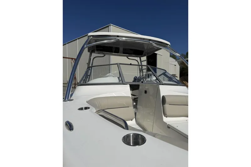 Slide: The Image of 2026 Key West 239 DFS boat with sleek design and comfortable seating, docked near a warehouse. - 5
