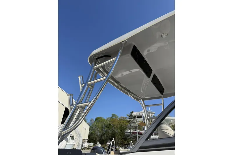 Slide: The Image of Key West 239 DFS 2026 boat with sleek metal framework and canopy under clear blue sky. - 6