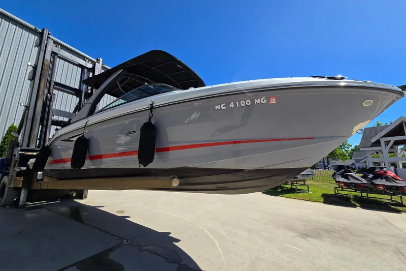 The Image of 2022 Sea Ray SLX 280 boat on a lift, showcasing sleek design and modern features. - 0
