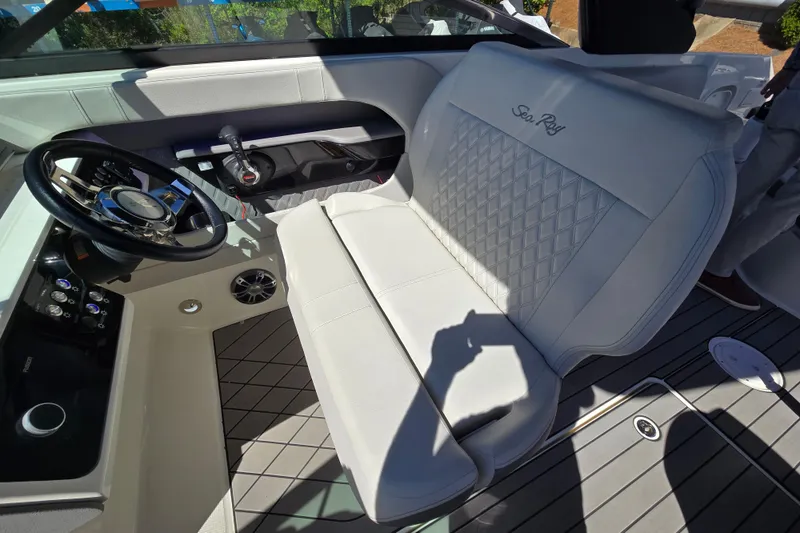 Slide: The Image of 2022 Sea Ray SLX 280 boat interior with white seating and steering wheel. - 11
