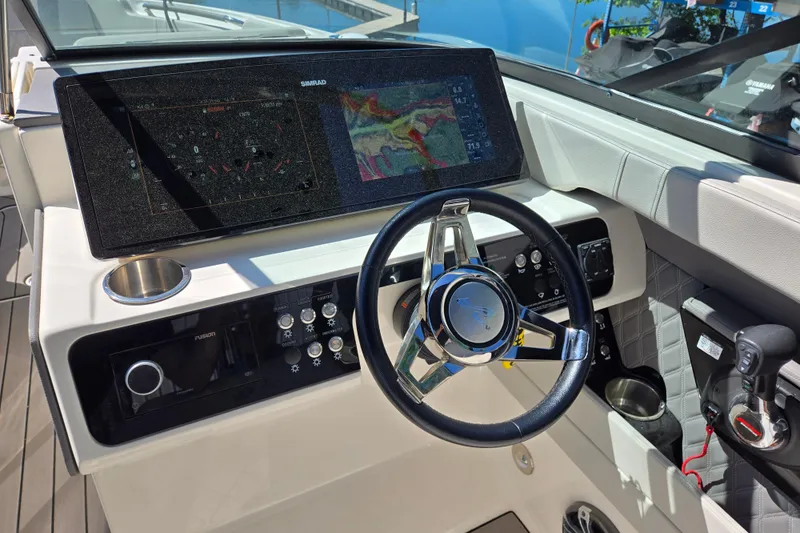Slide: The Image of 2022 Sea Ray SLX 280 helm with advanced navigation and control systems. - 12