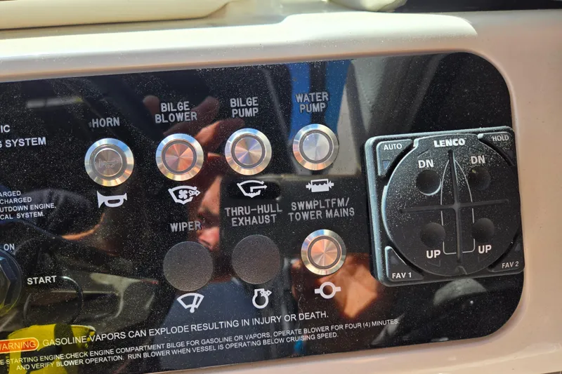 Slide: The Image of Control panel of a 2022 Sea Ray SLX 280 boat with various switches and buttons. - 14