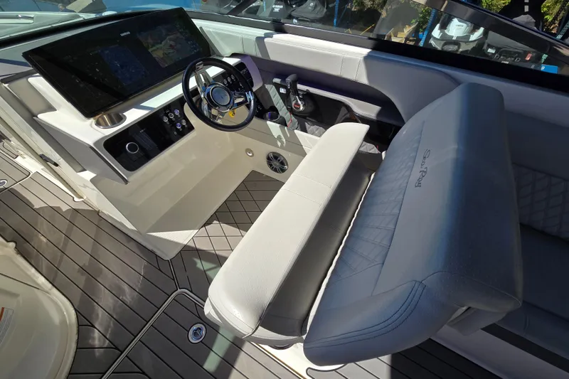 Slide: The Image of 2022 Sea Ray SLX 280 boat cockpit with modern steering and seating. - 15