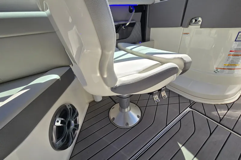 Slide: The Image of 2022 Sea Ray SLX 280 boat interior with cushioned seating and sleek flooring design. - 17