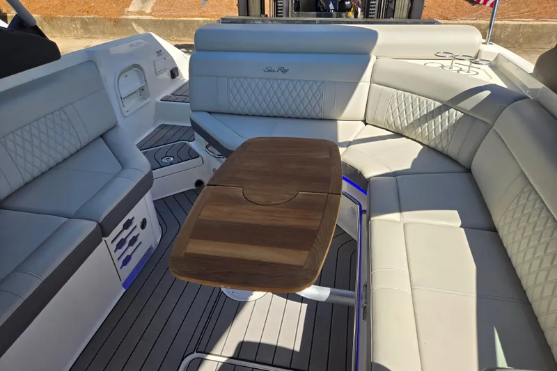 Slide: The Image of Luxurious interior of 2022 Sea Ray SLX 280 boat with elegant seating and wooden table. - 23