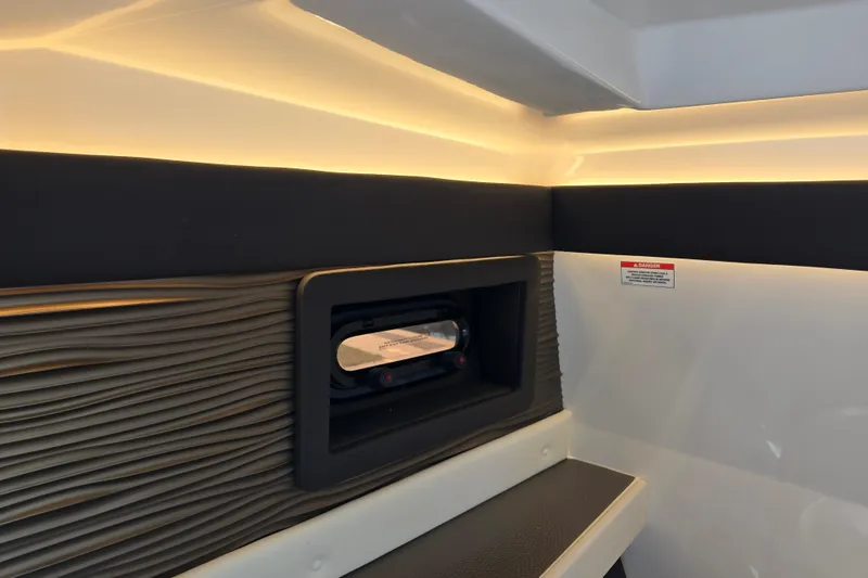Slide: The Image of Interior view of 2022 Sea Ray SLX 280 boat cabin with ambient lighting. - 36