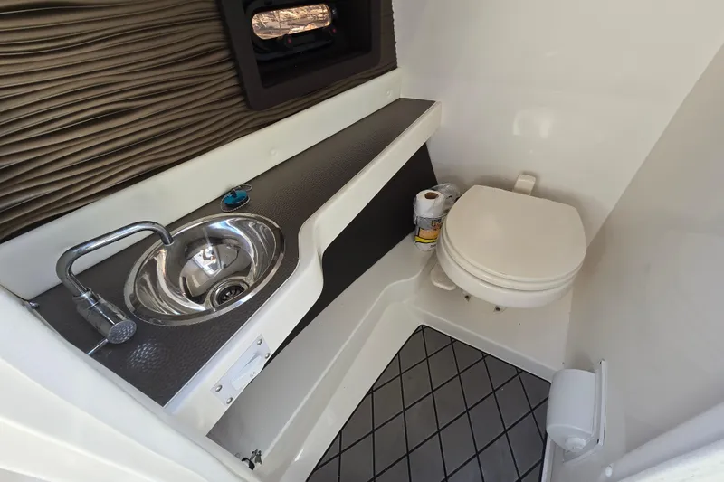 Slide: The Image of 2022 Sea Ray SLX 280 boat bathroom with sink and toilet. - 38