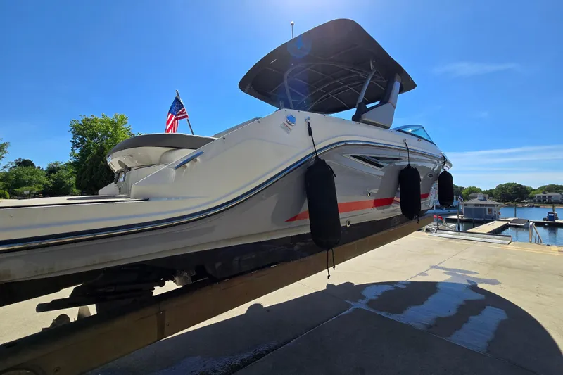 Slide: The Image of 2022 Sea Ray SLX 280 boat on lift, sunny day, American flag in background. - 4