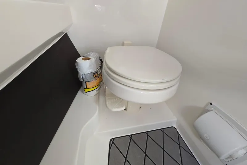Slide: The Image of 2022 Sea Ray SLX 280 boat bathroom with toilet and toilet paper. - 40