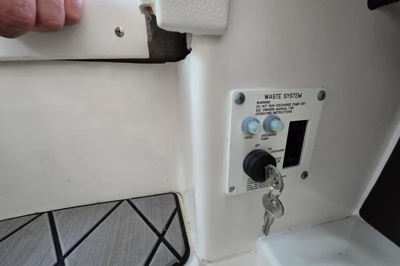 Slide: The Image of 2022 Sea Ray SLX 280 waste system control panel with keys inserted. - 41