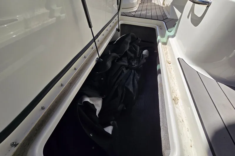 Slide: The Image of Storage compartment on a 2022 Sea Ray SLX 280 boat, featuring a black cover. - 44