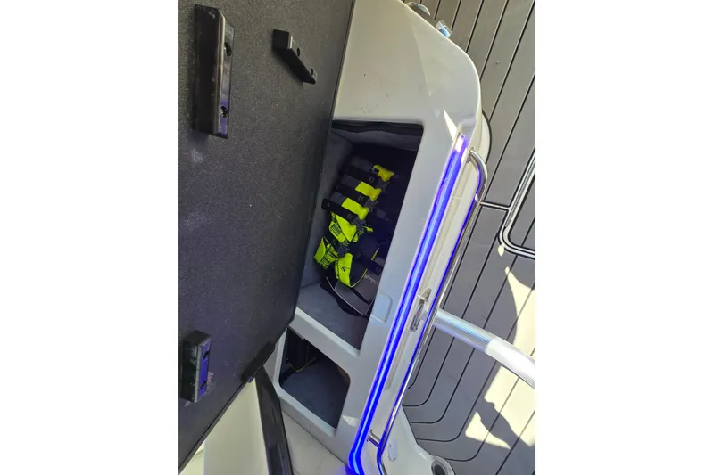 Slide: The Image of Storage compartment on a 2022 Sea Ray SLX 280 boat with life jackets. - 46
